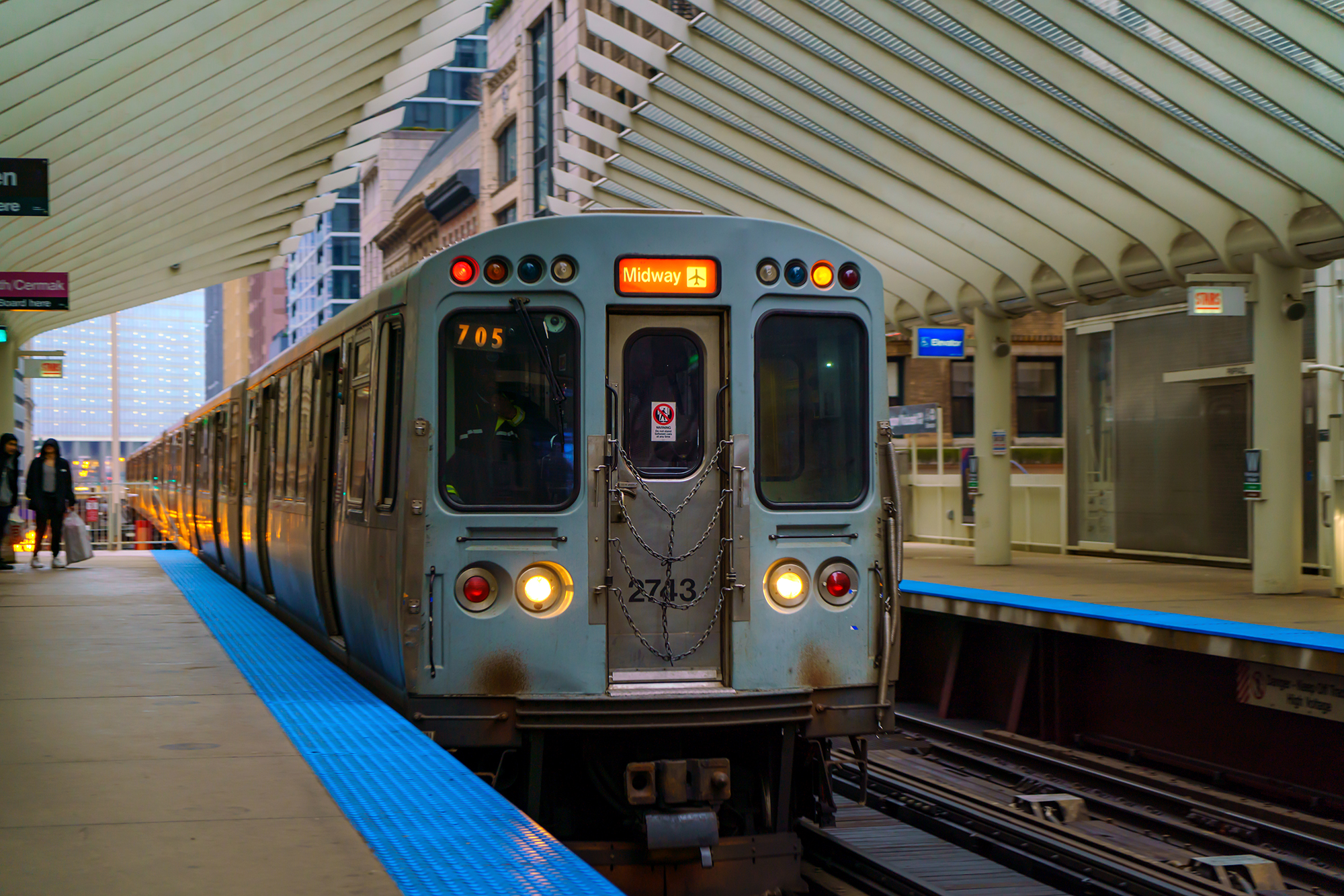 Chicago el train in station, orange Midway sign on front