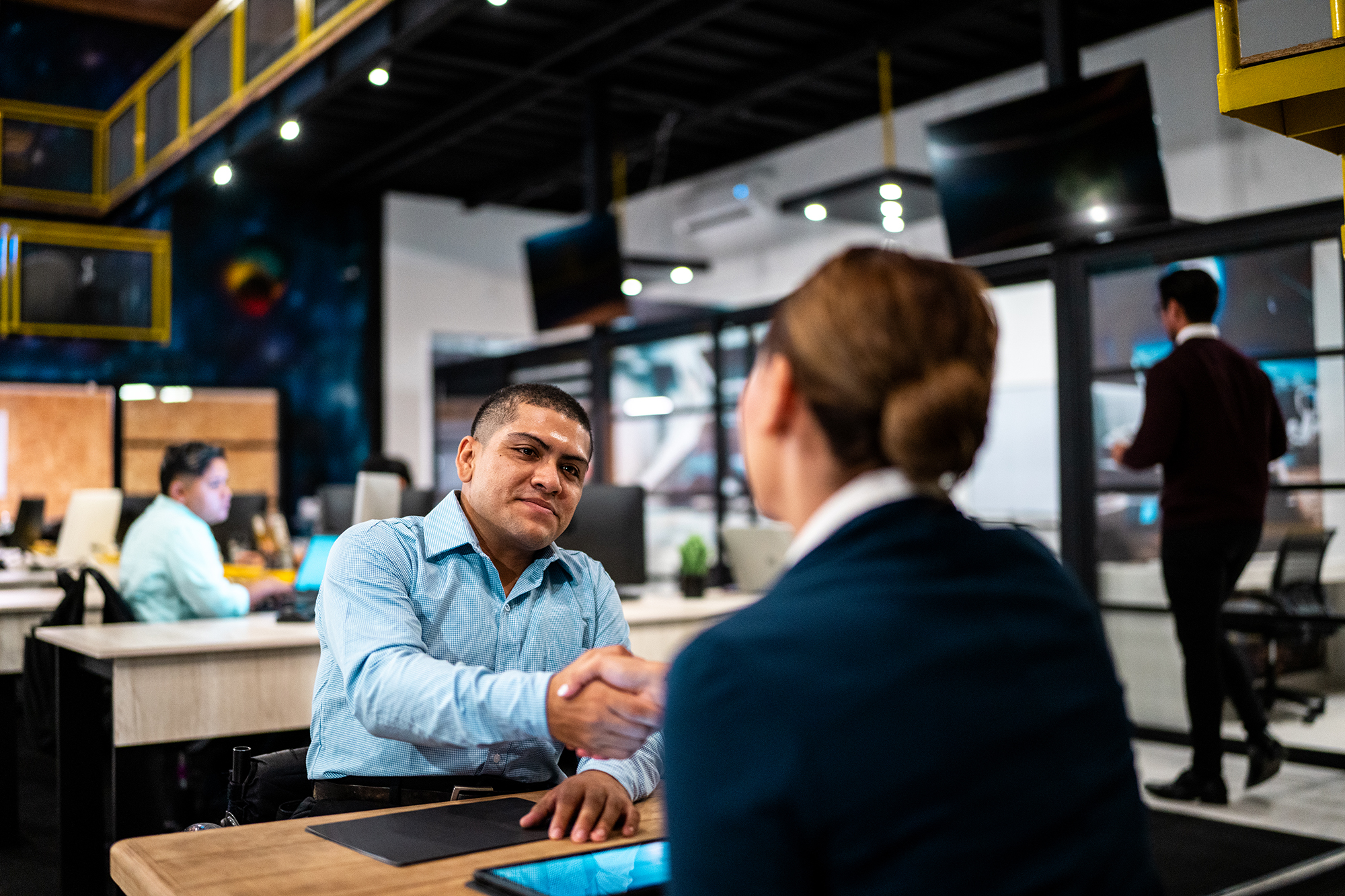 Professionals shaking hands across a table